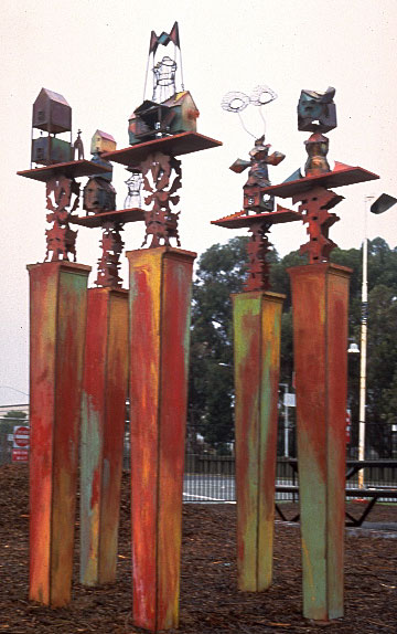 full shot of totems, towers topped with african inspired metal sculptures